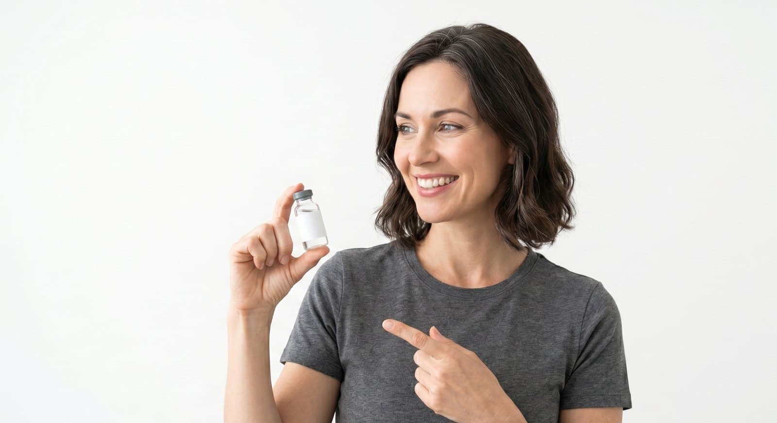 Smiling patient holding a small prescription vial